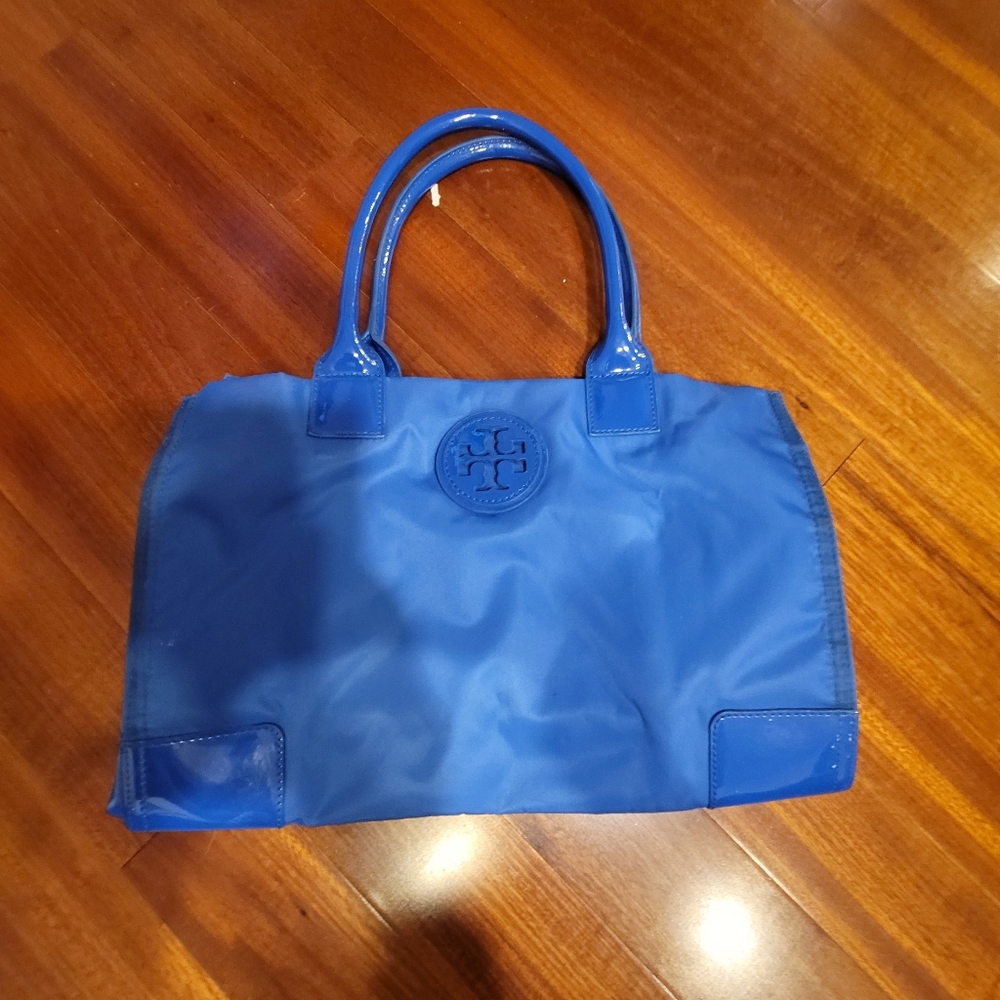 Tory burch blue ella.mini nylon tote. Has stain on the seams of the tote.